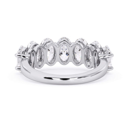 A picture of a seven stone diamond wedding ring with oval shaped diamonds that are shared prong set in white gold or platinum on a white background with a view of the underside of the ring.
