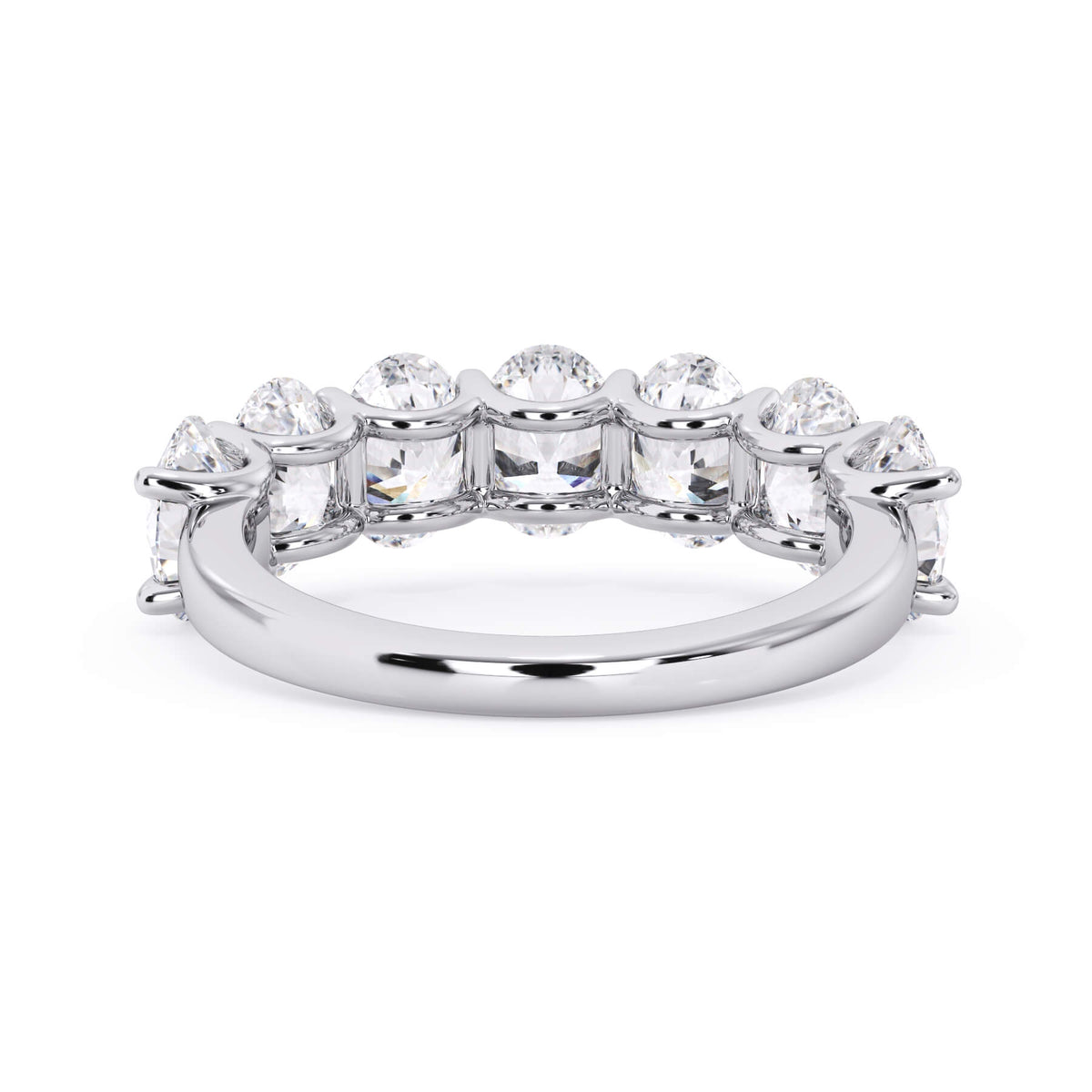 A picture of a seven stone diamond wedding ring with oval shaped diamonds that are U prong set in white gold or platinum on a white background with a view of the underside of the ring.