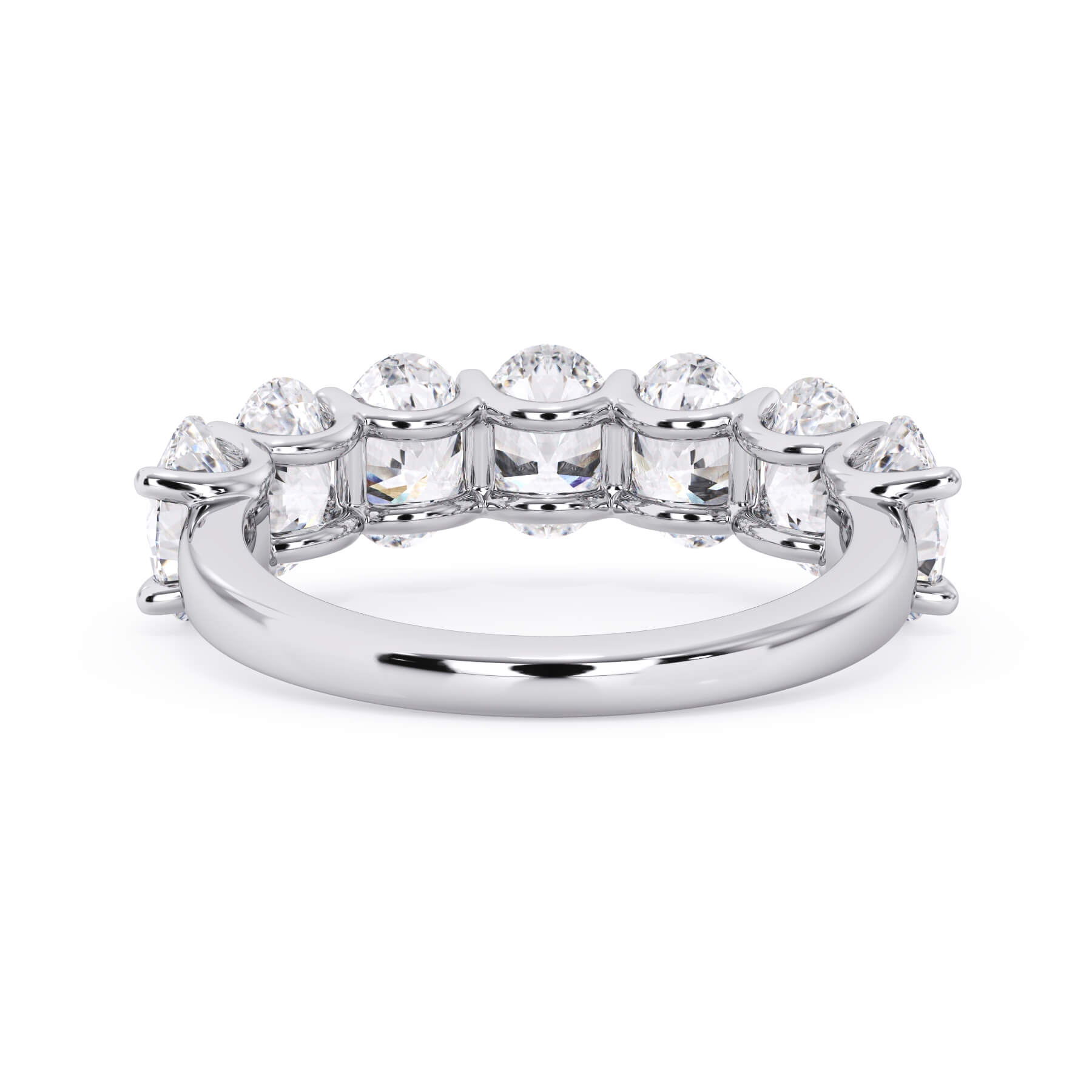 A picture of a seven stone diamond wedding ring with oval shaped diamonds that are U prong set in white gold or platinum on a white background with a view of the underside of the ring.