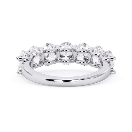 A picture of a seven stone diamond wedding ring with oval shaped diamonds that are U prong set in white gold or platinum on a white background with a view of the underside of the ring.