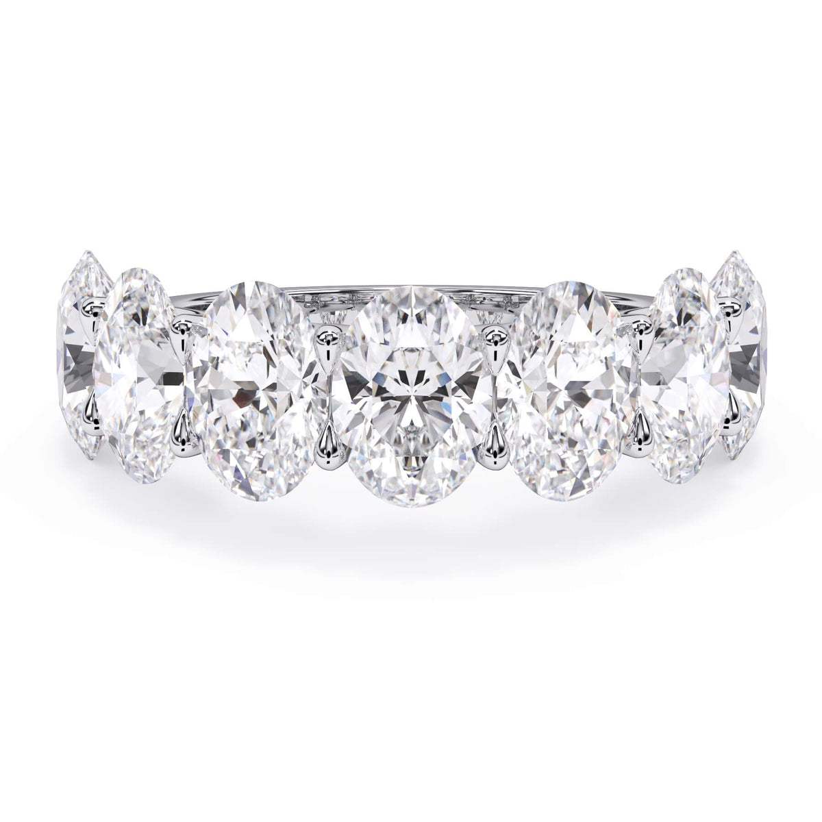 A picture of a seven stone diamond wedding ring with oval shaped diamonds that are U prong set in white gold or platinum on a white background with the ring facing forward, lying down.
