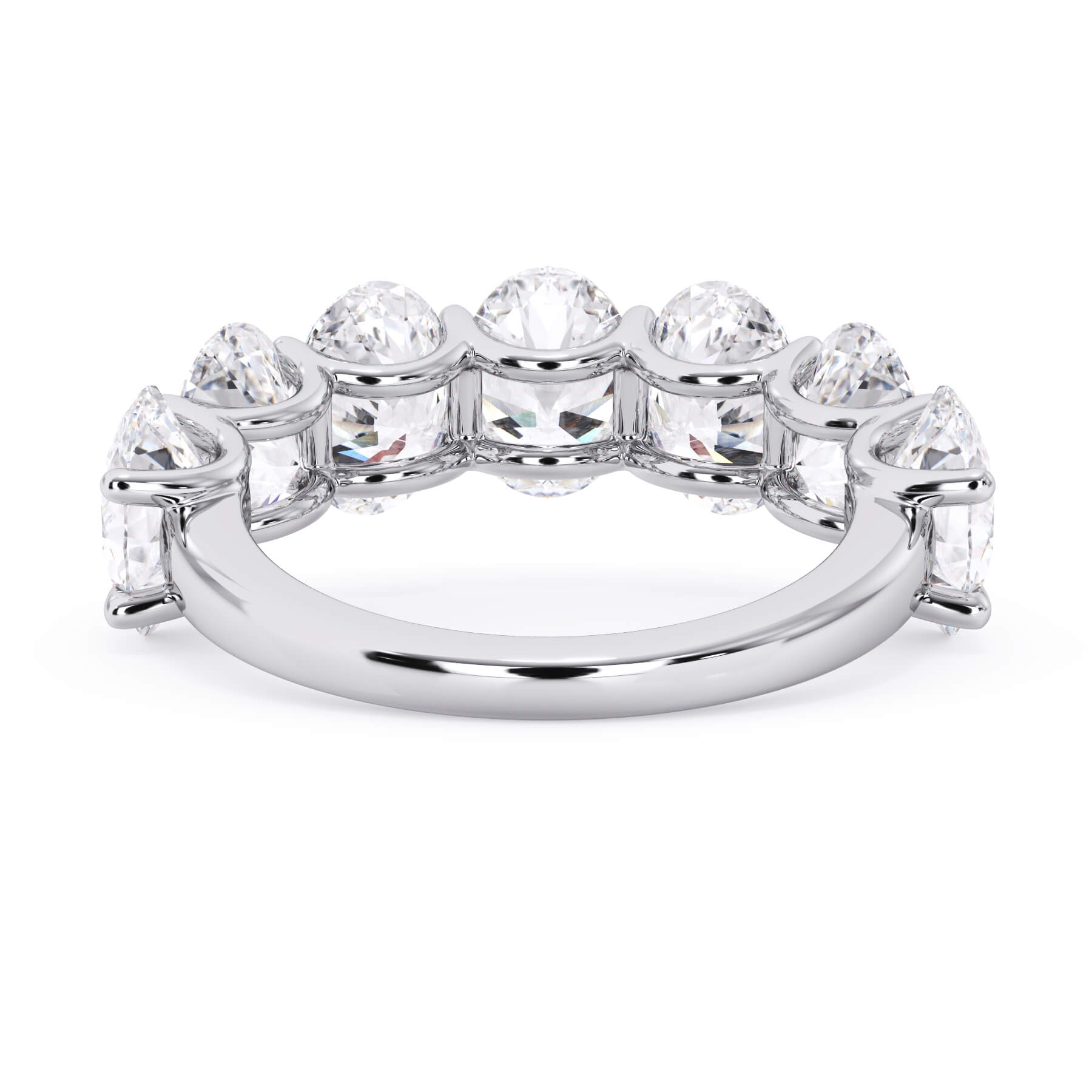 A picture of a seven stone diamond wedding ring with oval shaped diamonds that are U prong set in white gold or platinum on a white background with a view of the underside of the ring.
