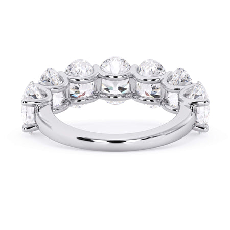 A picture of a seven stone diamond wedding ring with oval shaped diamonds that are U prong set in white gold or platinum on a white background with a view of the underside of the ring.