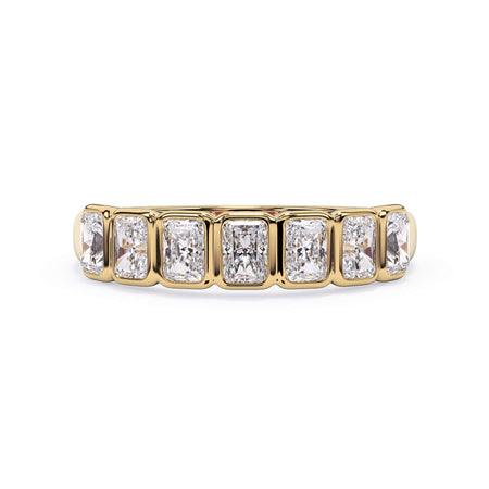 A picture of a seven stone diamond wedding ring with radiant cut diamonds that are bezel set in yellow gold on a white background with the ring facing forward, lying down.