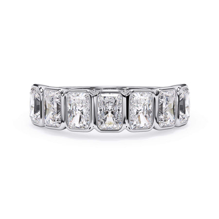 A picture of a seven stone diamond wedding ring with radiant cut diamonds that are bezel set in white gold or platinum on a white background with the ring facing forward, lying down.