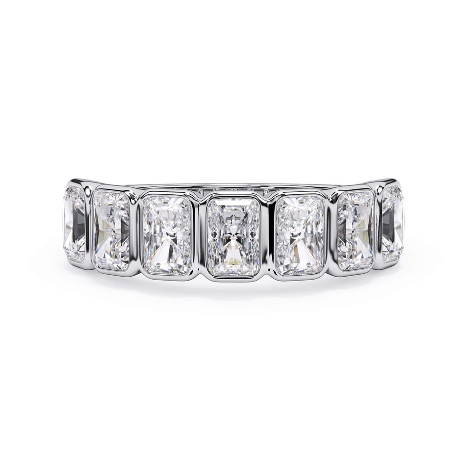 A picture of a seven stone diamond wedding ring with radiant cut diamonds that are bezel set in white gold or platinum on a white background with the ring facing forward, lying down.