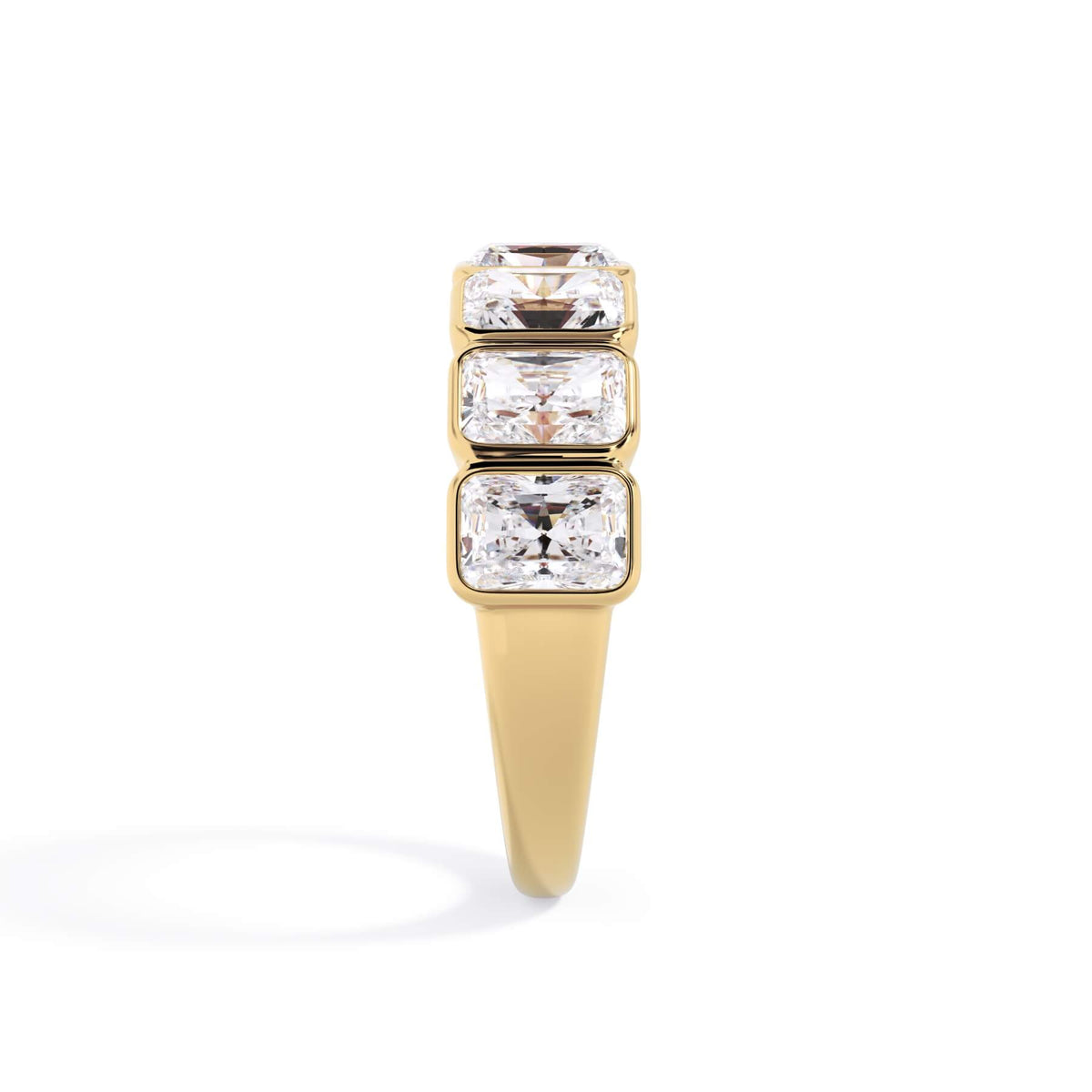 A picture of a seven stone diamond wedding ring with radiant cut diamonds that are bezel set in yellow gold on a white background with a side profile view.