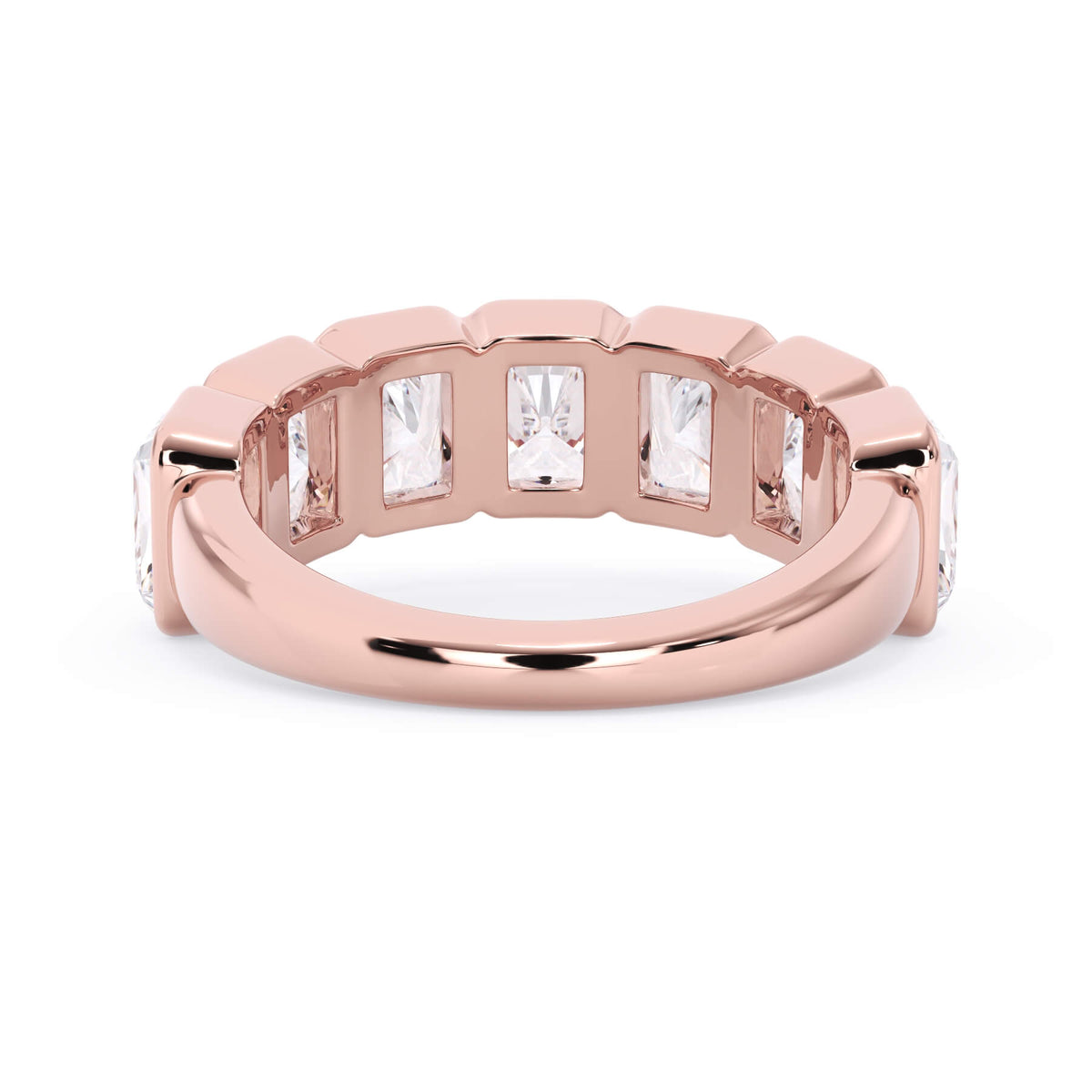 A picture of a seven stone diamond wedding ring with radiant cut diamonds that are bezel set in rose gold on a white background with a view of the underside of the ring.
