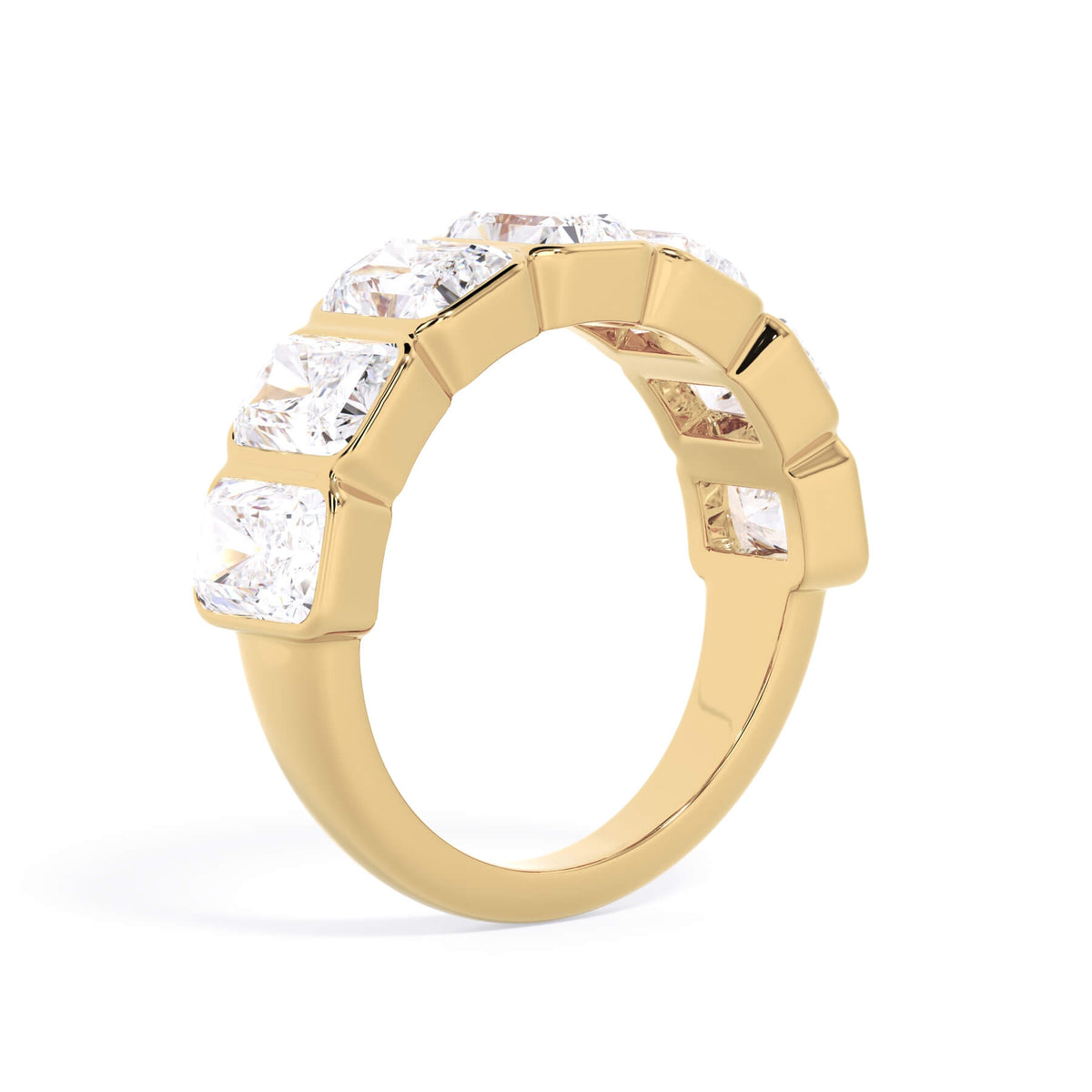 A picture of a seven stone diamond wedding ring with radiant cut diamonds that are bezel set in yellow gold on a white background with a slightly angled, through the finger view.