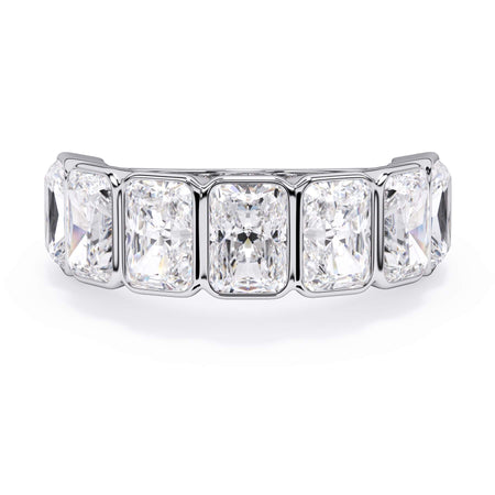A picture of a seven stone diamond wedding ring with radiant cut diamonds that are bezel set in white gold or platinum on a white background with the ring facing forward, lying down.