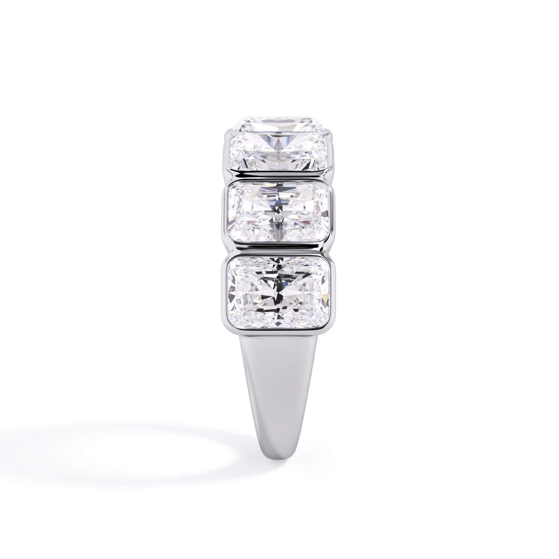 A picture of a seven stone diamond wedding ring with radiant cut diamonds that are bezel set in white gold or platinum on a white background with a side profile view.