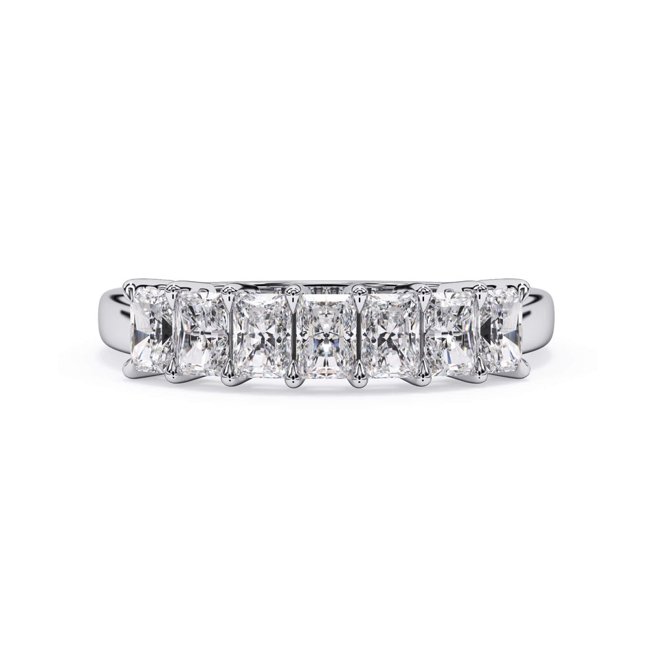 A picture of a seven stone diamond wedding ring with radiant cut diamonds that are shared prong set in white gold or platinum on a white background with the ring facing forward, lying down.