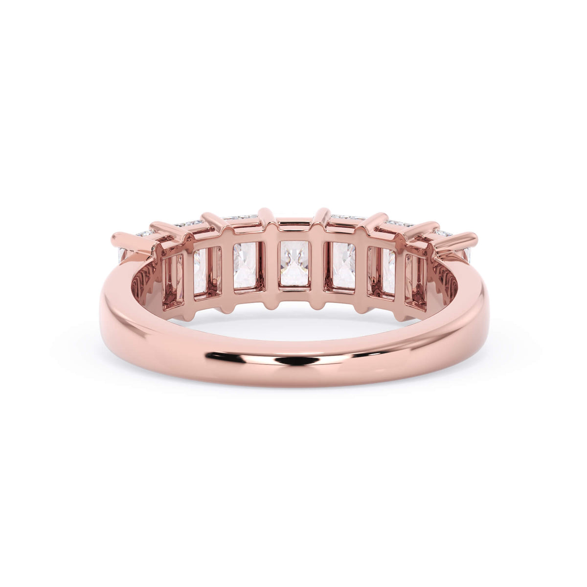 A picture of a seven stone diamond wedding ring with radiant cut diamonds that are shared prong set in rose gold on a white background with a view of the underside of the ring.