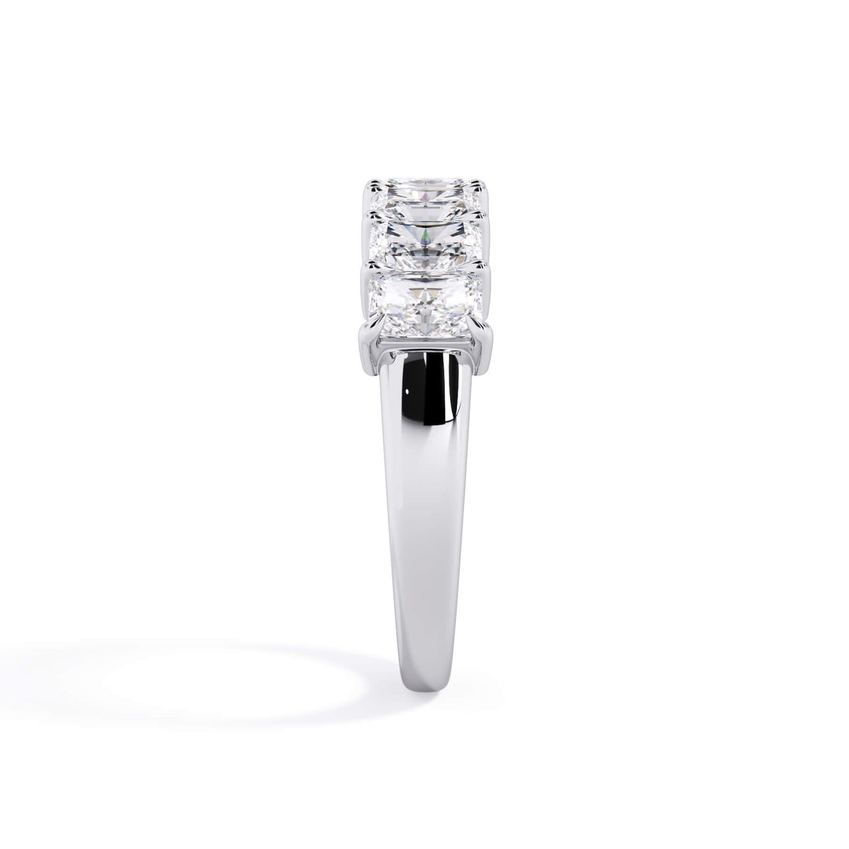 A picture of a seven stone diamond wedding ring with radiant cut diamonds that are shared prong set in white gold or platinum on a white background with a side profile view.