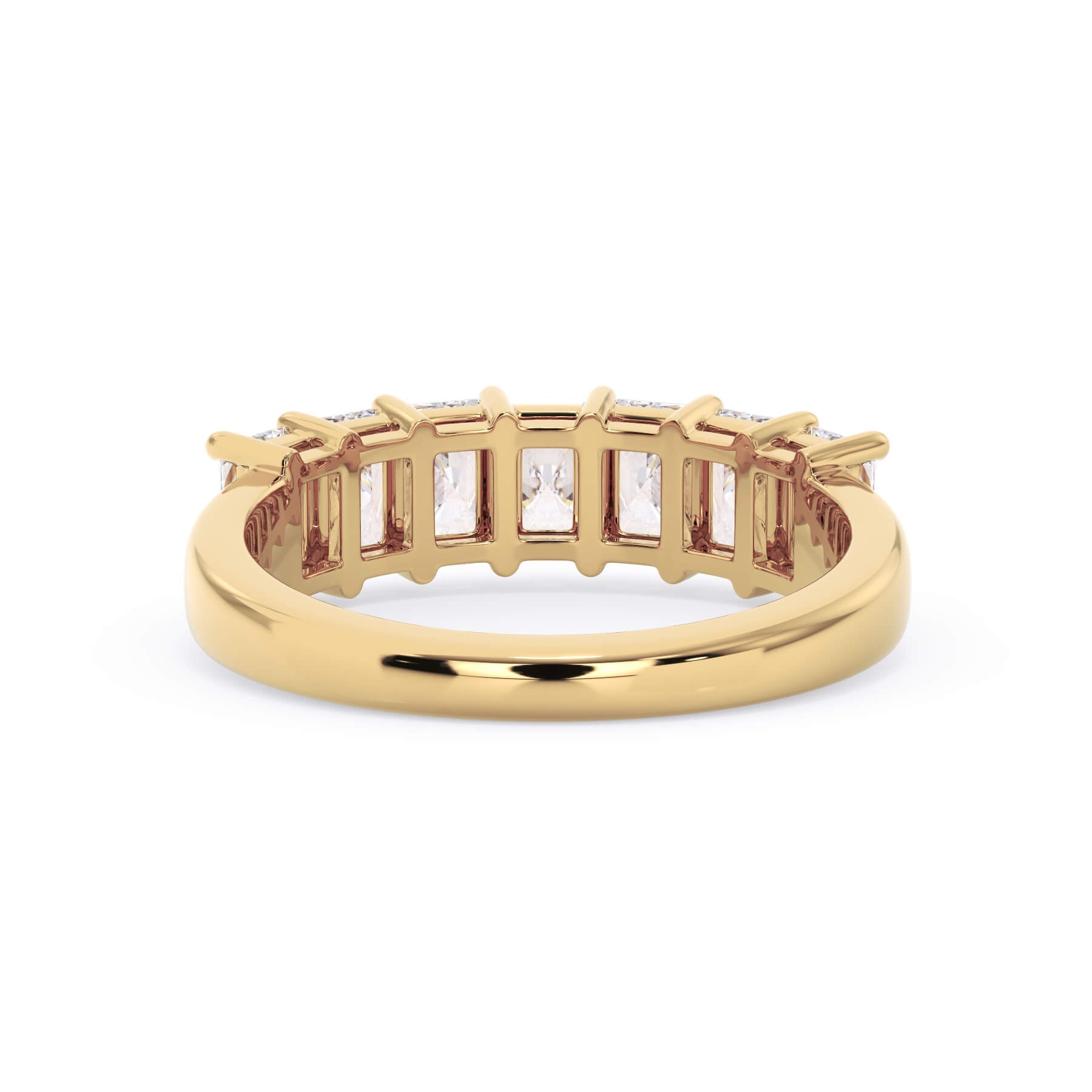 A picture of a seven stone diamond wedding ring with radiant cut diamonds that are shared prong set in yellow gold on a white background with a view of the underside of the ring.