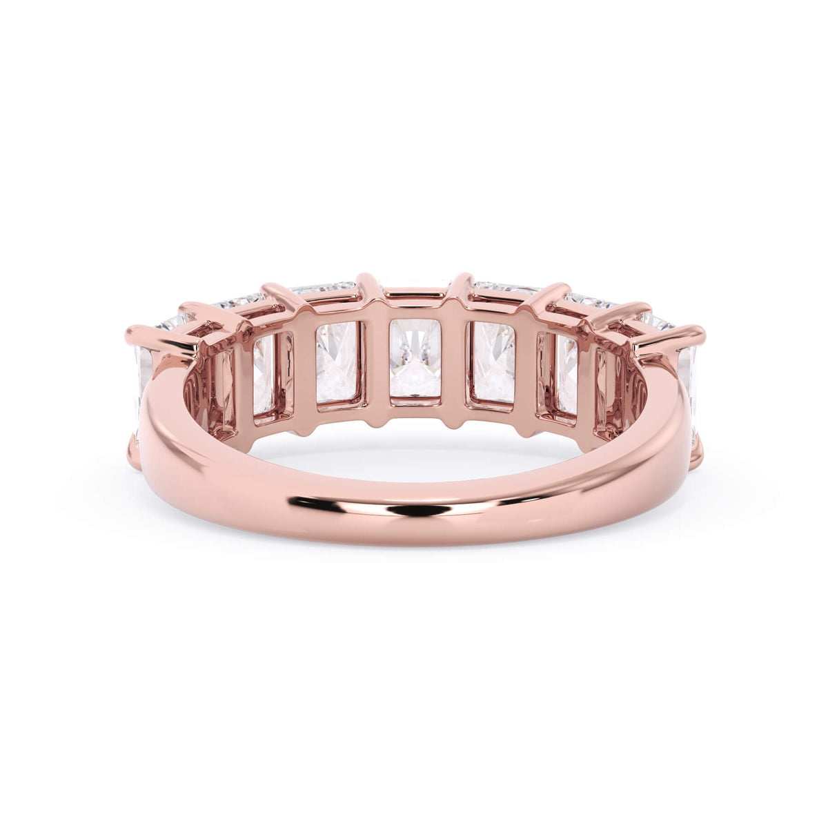 A picture of a seven stone diamond wedding ring with radiant cut diamonds that are shared prong set in rose gold on a white background with a view of the underside of the ring.