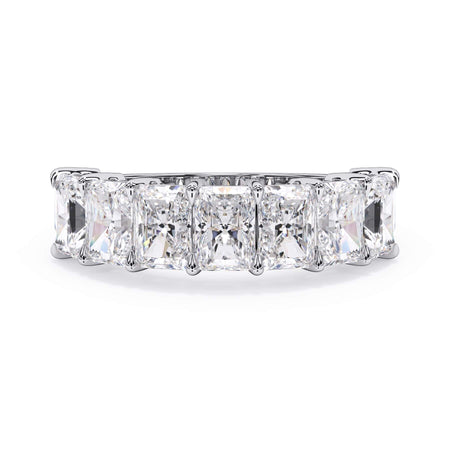 A picture of a seven stone diamond wedding ring with radiant cut diamonds that are shared prong set in white gold or platinum on a white background with the ring facing forward, lying down.