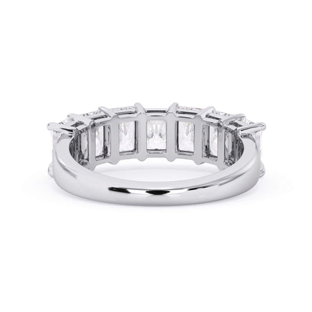 A picture of a seven stone diamond wedding ring with radiant cut diamonds that are shared prong set in white gold or platinum on a white background with a view of the underside of the ring.