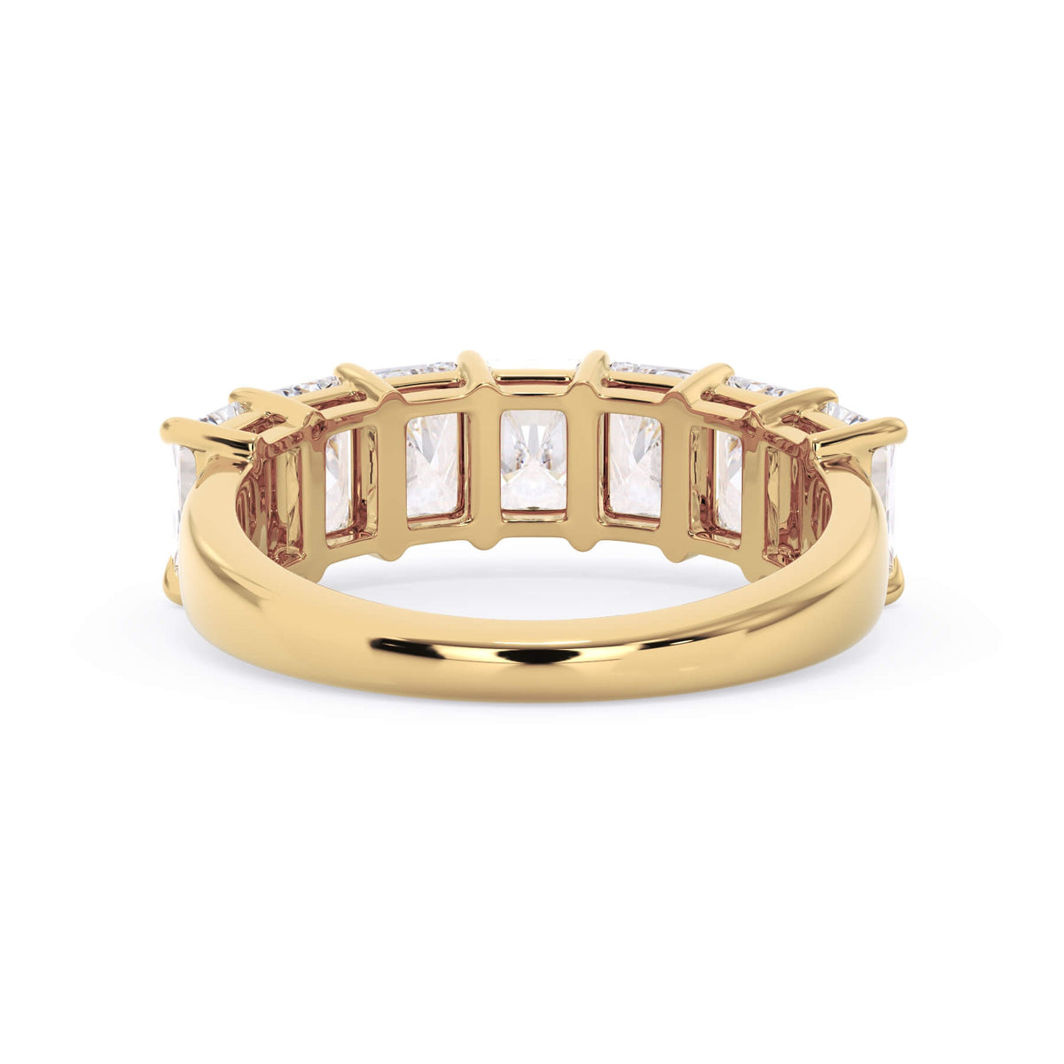 A picture of a seven stone diamond wedding ring with radiant cut diamonds that are shared prong set in yellow gold on a white background with a view of the underside of the ring.