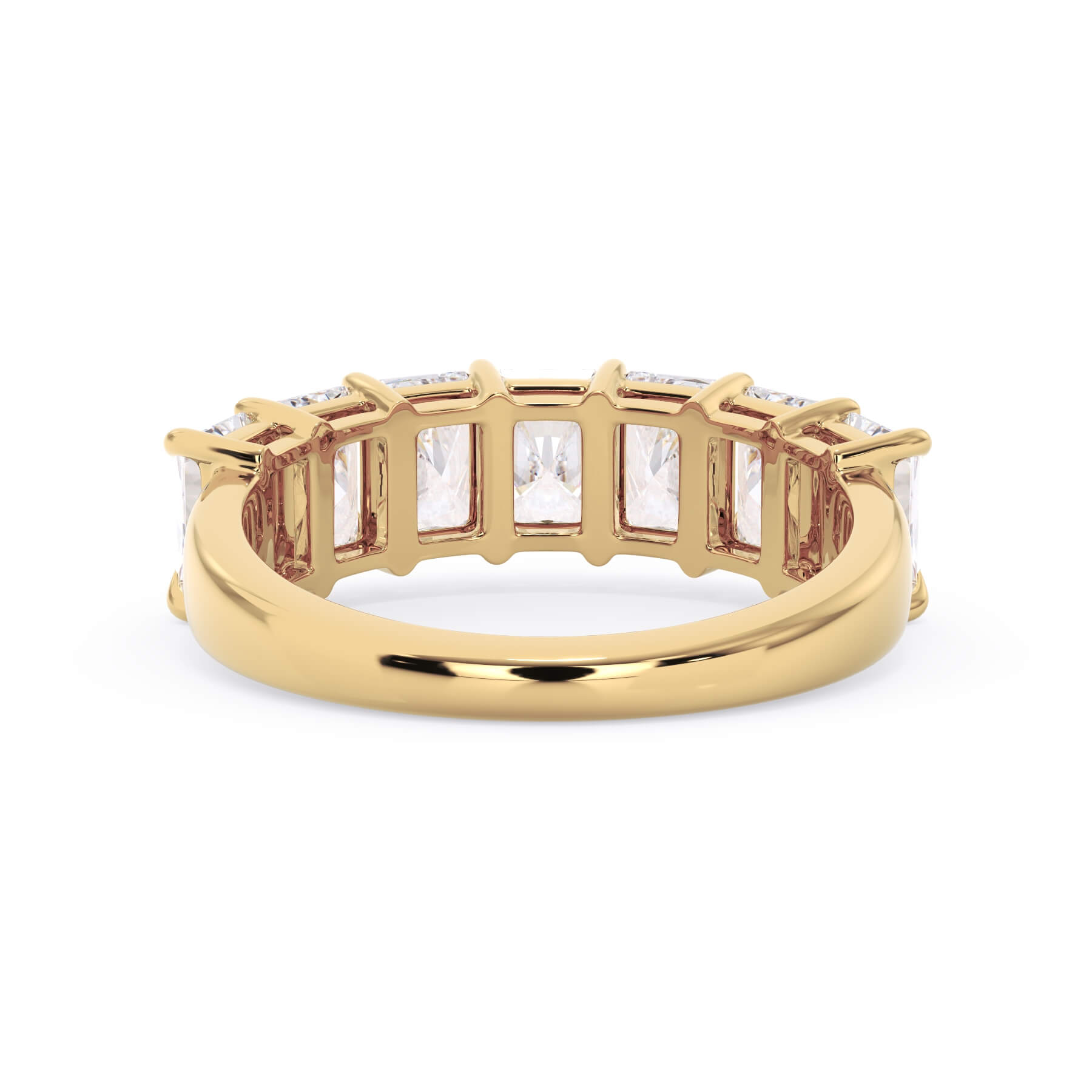 A picture of a seven stone diamond wedding ring with radiant cut diamonds that are shared prong set in yellow gold on a white background with a view of the underside of the ring.