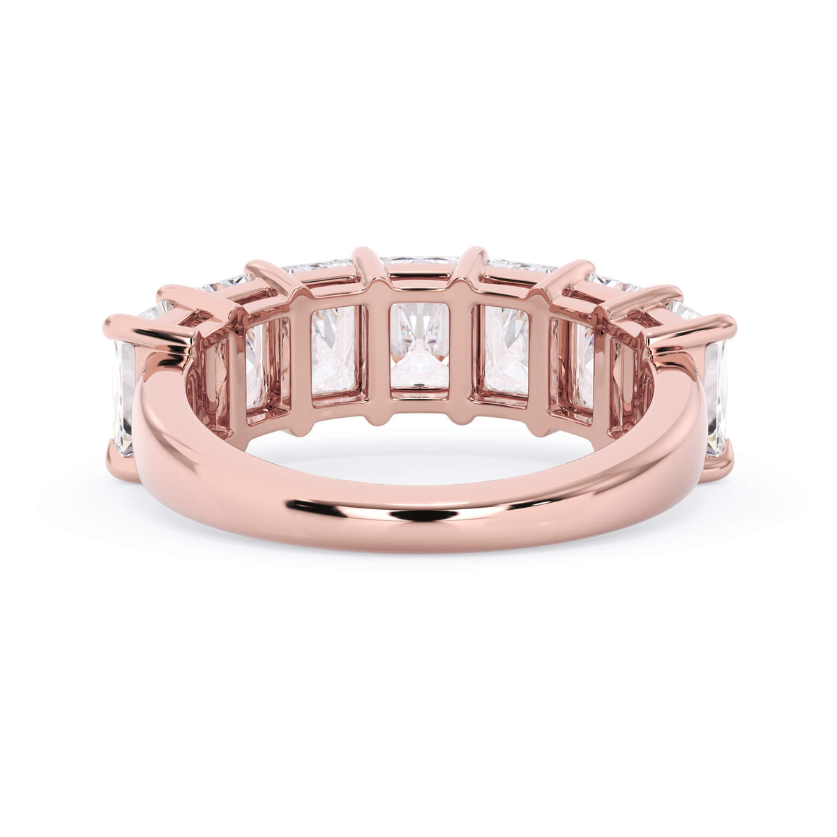 A picture of a seven stone diamond wedding ring with radiant cut diamonds that are shared prong set in rose gold on a white background with a view of the underside of the ring.