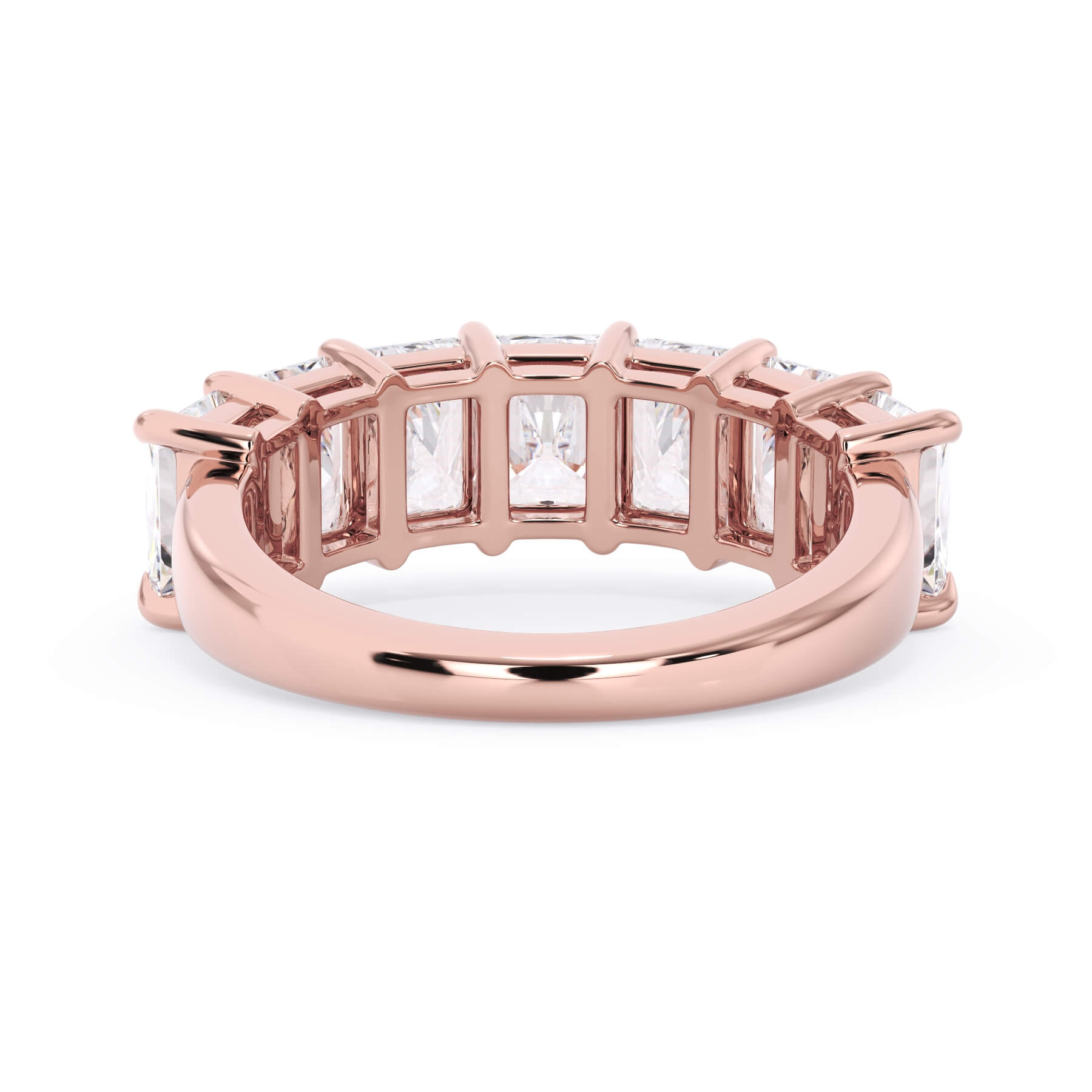 A picture of a seven stone diamond wedding ring with radiant cut diamonds that are shared prong set in rose gold on a white background with a view of the underside of the ring.