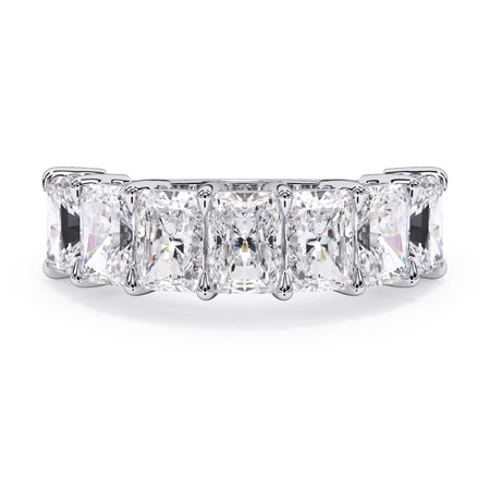 A picture of a seven stone diamond wedding ring with radiant cut diamonds that are shared prong set in white gold or platinum on a white background with the ring facing forward, lying down.