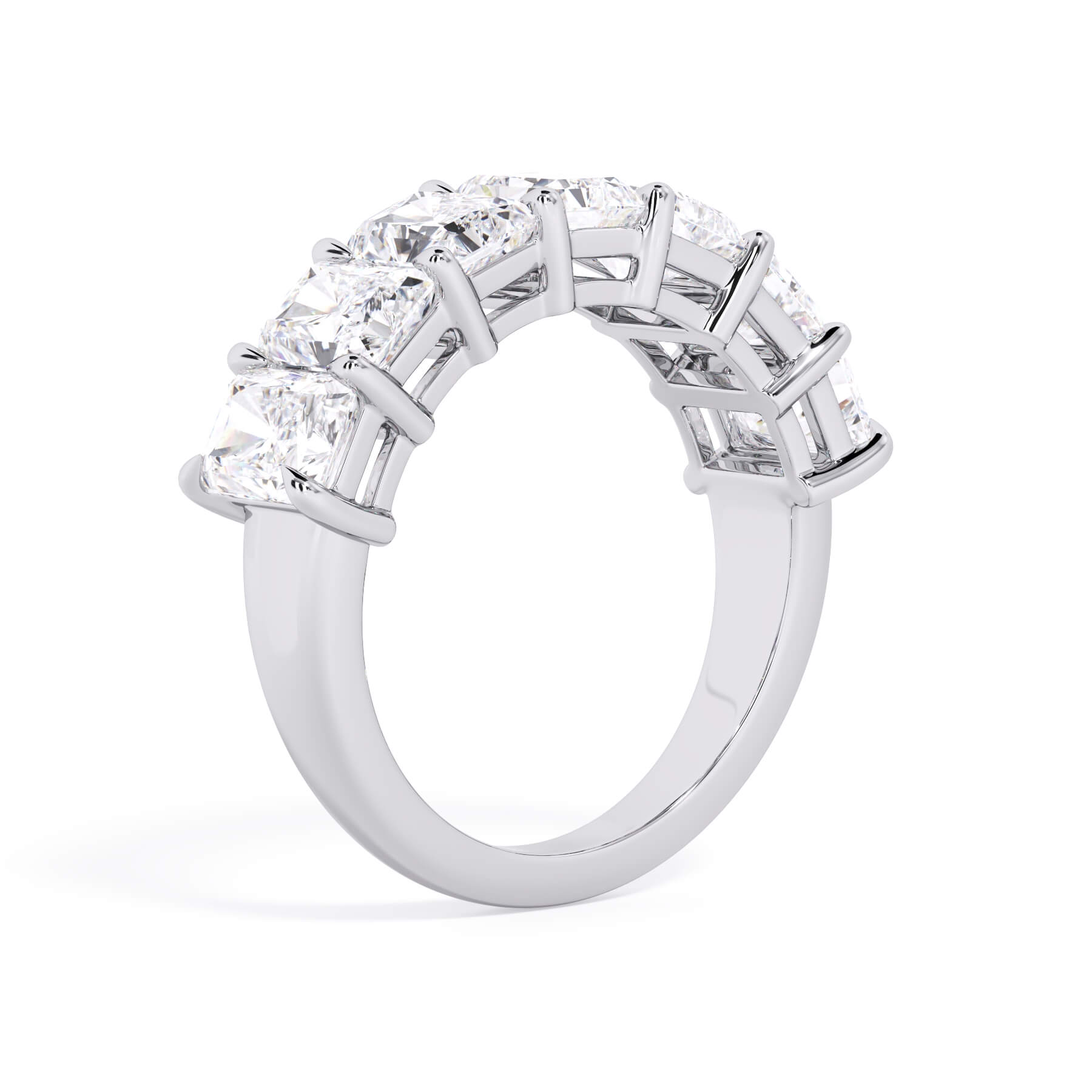 A picture of a seven stone diamond wedding ring with radiant cut diamonds that are shared prong set in white gold or platinum on a white background with a slightly angled, through the finger view.