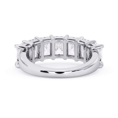 A picture of a seven stone diamond wedding ring with radiant cut diamonds that are shared prong set in white gold or platinum on a white background with a view of the underside of the ring.