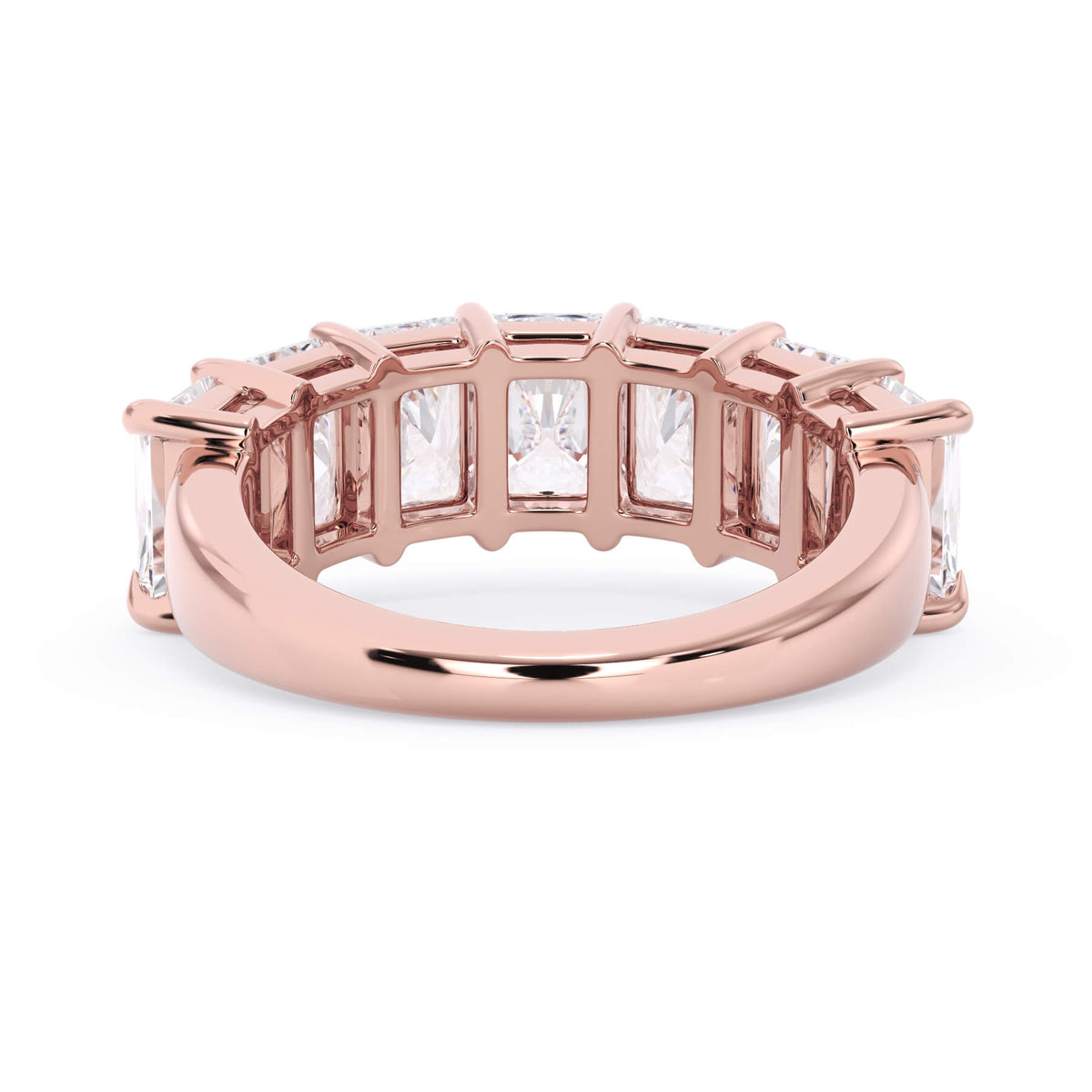 A picture of a seven stone diamond wedding ring with radiant cut diamonds that are shared prong set in rose gold on a white background with a view of the underside of the ring.