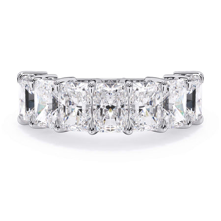A picture of a seven stone diamond wedding ring with radiant cut diamonds that are shared prong set in white gold or platinum on a white background with the ring facing forward, lying down.