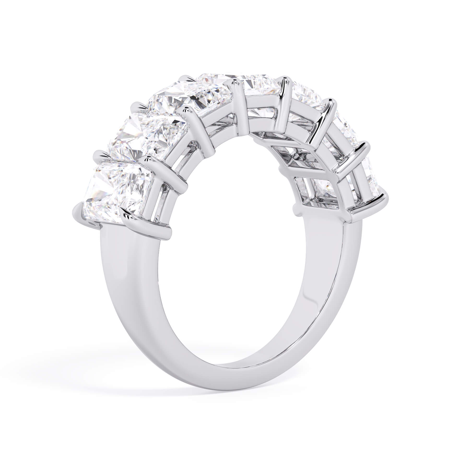 A picture of a seven stone diamond wedding ring with radiant cut diamonds that are shared prong set in white gold or platinum on a white background with a slightly angled, through the finger view.