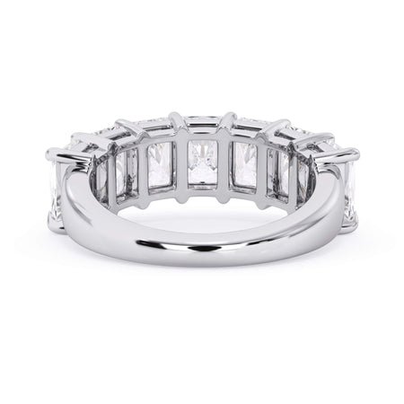 A picture of a seven stone diamond wedding ring with radiant cut diamonds that are shared prong set in white gold or platinum on a white background with a view of the underside of the ring.