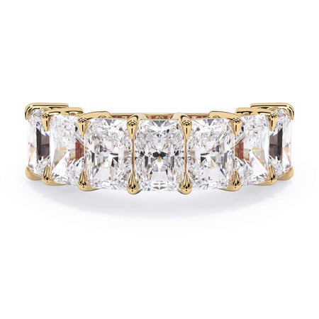 A picture of a seven stone diamond wedding ring with radiant cut diamonds that are shared prong set in yellow gold on a white background with the ring facing forward, lying down.