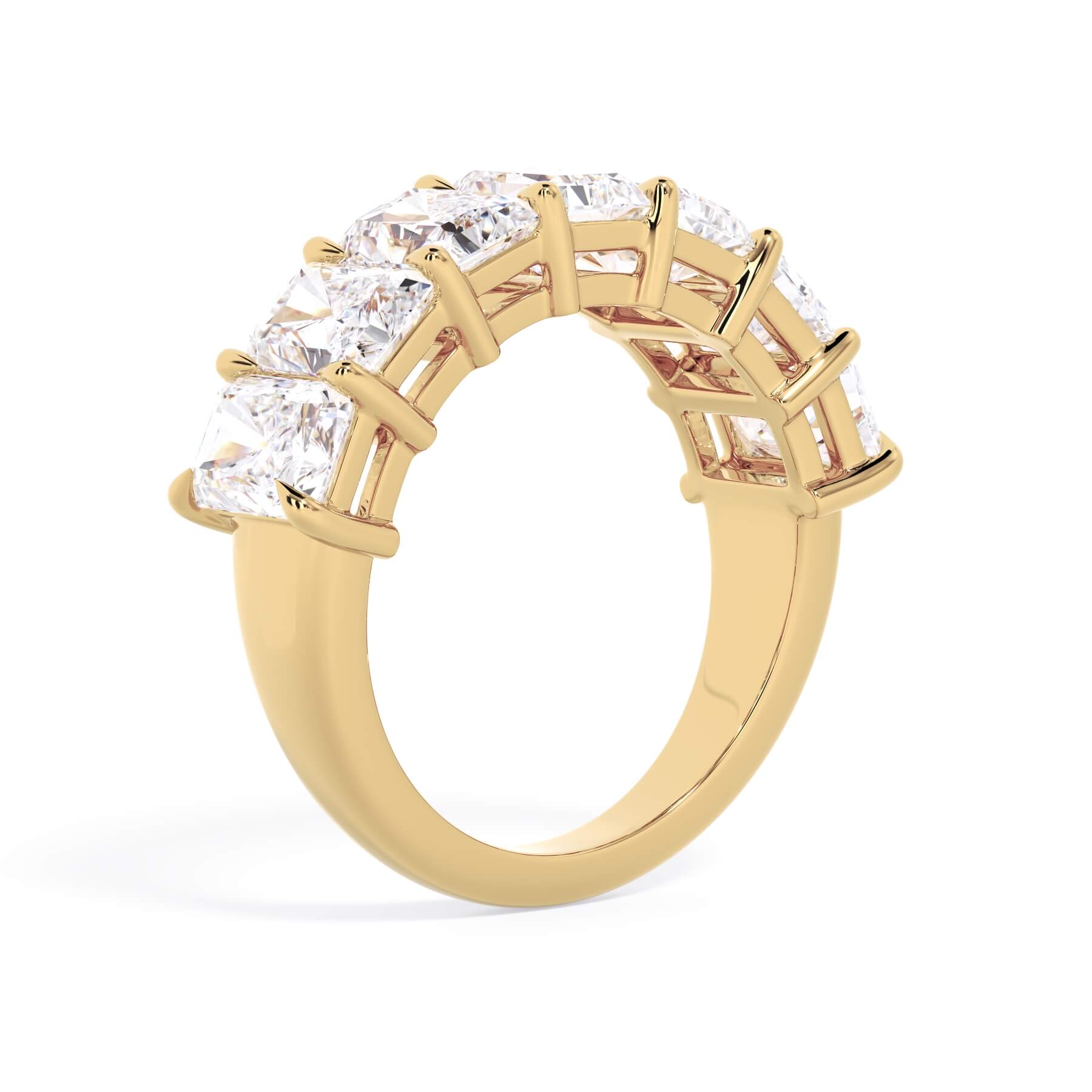 A picture of a seven stone diamond wedding ring with radiant cut diamonds that are shared prong set in yellow gold on a white background with a slightly angled, through the finger view.