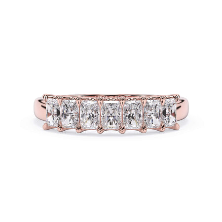 A picture of a seven stone diamond wedding ring with radiant cut diamonds that are U prong set in rose gold on a white background with the ring facing forward, lying down.