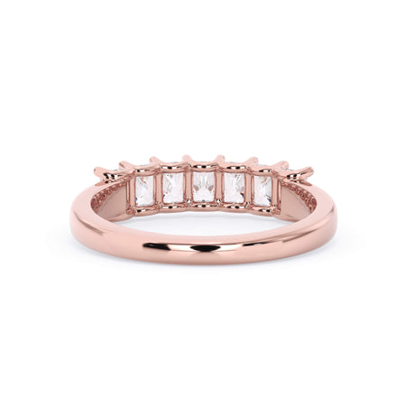A picture of a seven stone diamond wedding ring with radiant cut diamonds that are U prong set in rose gold on a white background with a view of the underside of the ring.