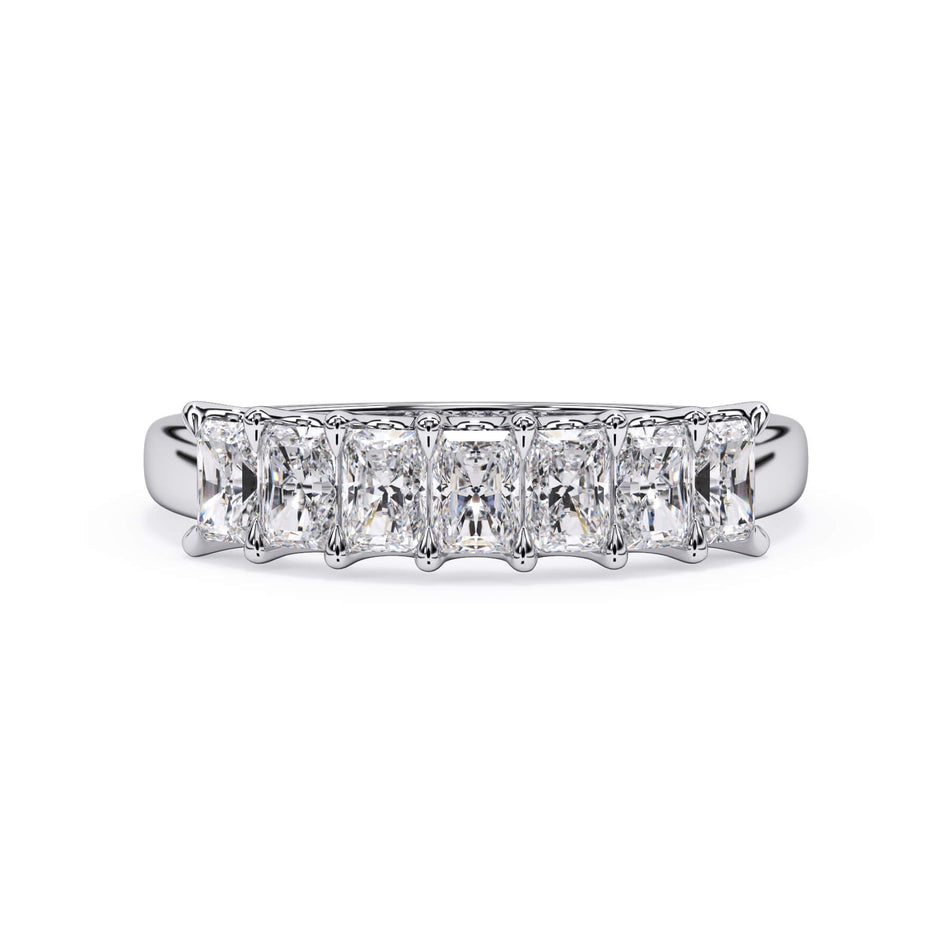 A picture of a seven stone diamond wedding ring with radiant cut diamonds that are U prong set in white gold or platinum on a white background with the ring facing forward, lying down.