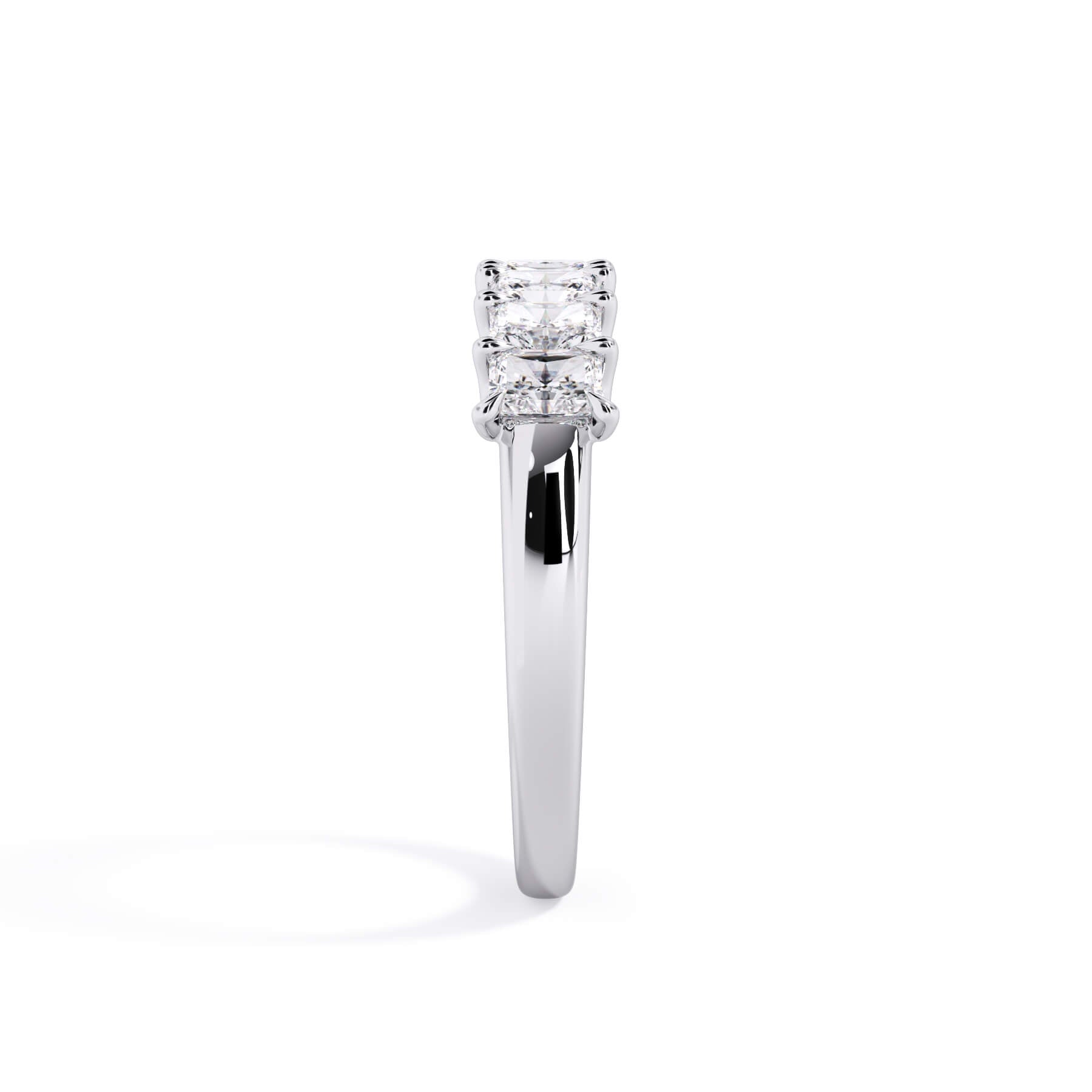 A picture of a seven stone diamond wedding ring with radiant cut diamonds that are U prong set in white gold or platinum on a white background with a side profile view.