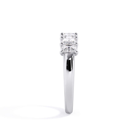 A picture of a seven stone diamond wedding ring with radiant cut diamonds that are U prong set in white gold or platinum on a white background with a side profile view.
