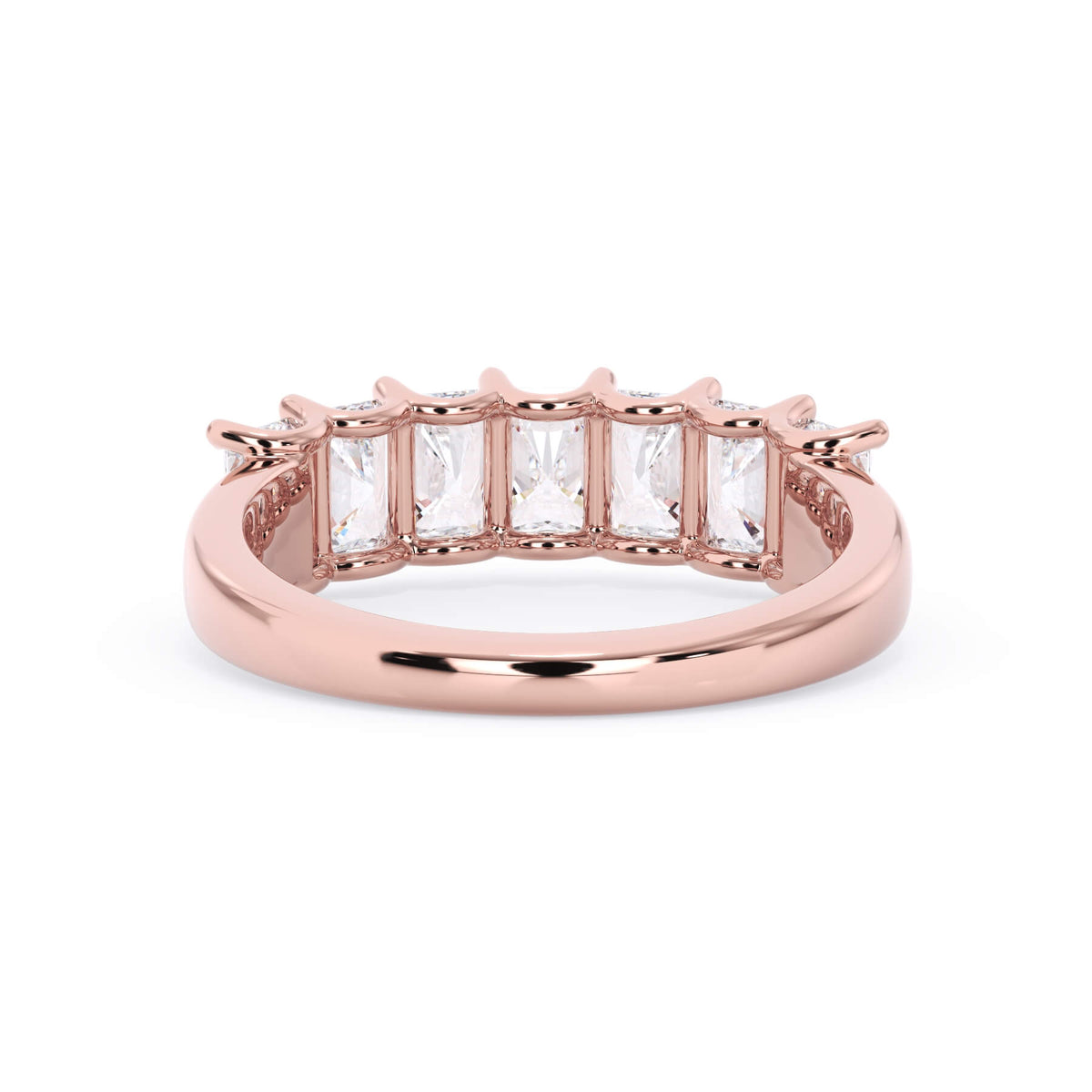A picture of a seven stone diamond wedding ring with radiant cut diamonds that are U prong set in rose gold on a white background with a view of the underside of the ring.