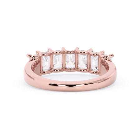 A picture of a seven stone diamond wedding ring with radiant cut diamonds that are U prong set in rose gold on a white background with a view of the underside of the ring.
