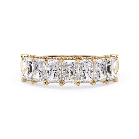 A picture of a seven stone diamond wedding ring with radiant cut diamonds that are U prong set in yellow gold on a white background with the ring facing forward, lying down.