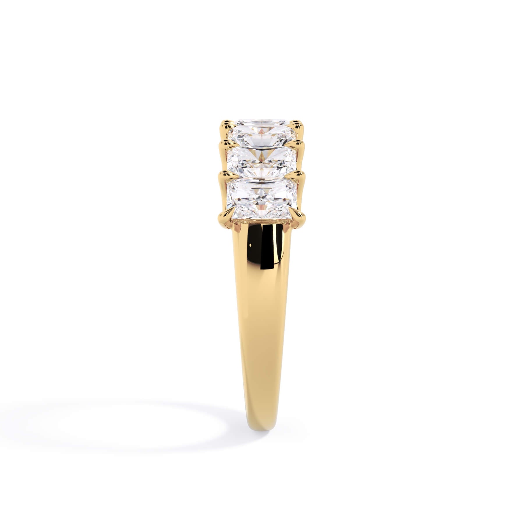 A picture of a seven stone diamond wedding ring with radiant cut diamonds that are U prong set in yellow gold on a white background with a side profile view.