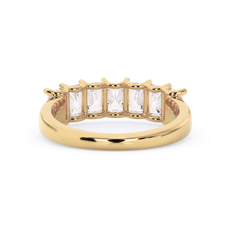 A picture of a seven stone diamond wedding ring with radiant cut diamonds that are U prong set in yellow gold on a white background with a view of the underside of the ring.