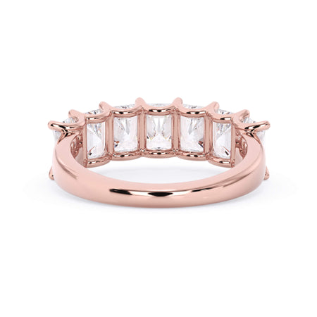 A picture of a seven stone diamond wedding ring with radiant cut diamonds that are U prong set in rose gold on a white background with a view of the underside of the ring.