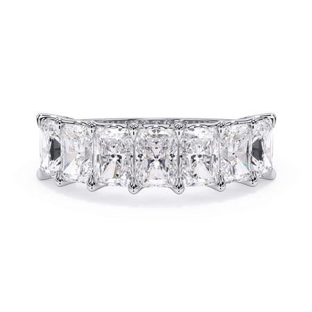 A picture of a seven stone diamond wedding ring with radiant cut diamonds that are U prong set in white gold or platinum on a white background with the ring facing forward, lying down.