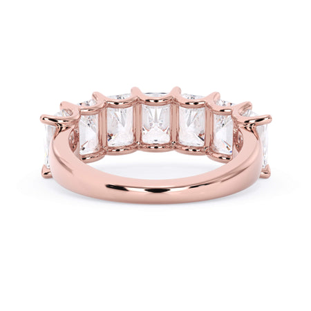 A picture of a seven stone diamond wedding ring with radiant cut diamonds that are U prong set in rose gold on a white background with the ring facing forward, lying down.