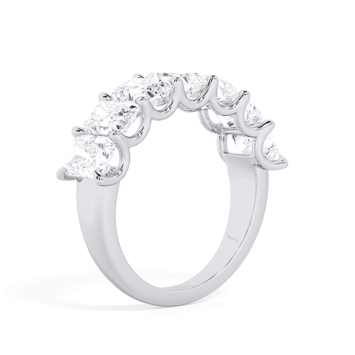 A picture of a seven stone diamond wedding ring with radiant cut diamonds that are U prong set in white gold or platinum on a white background with the ring facing forward, lying down.