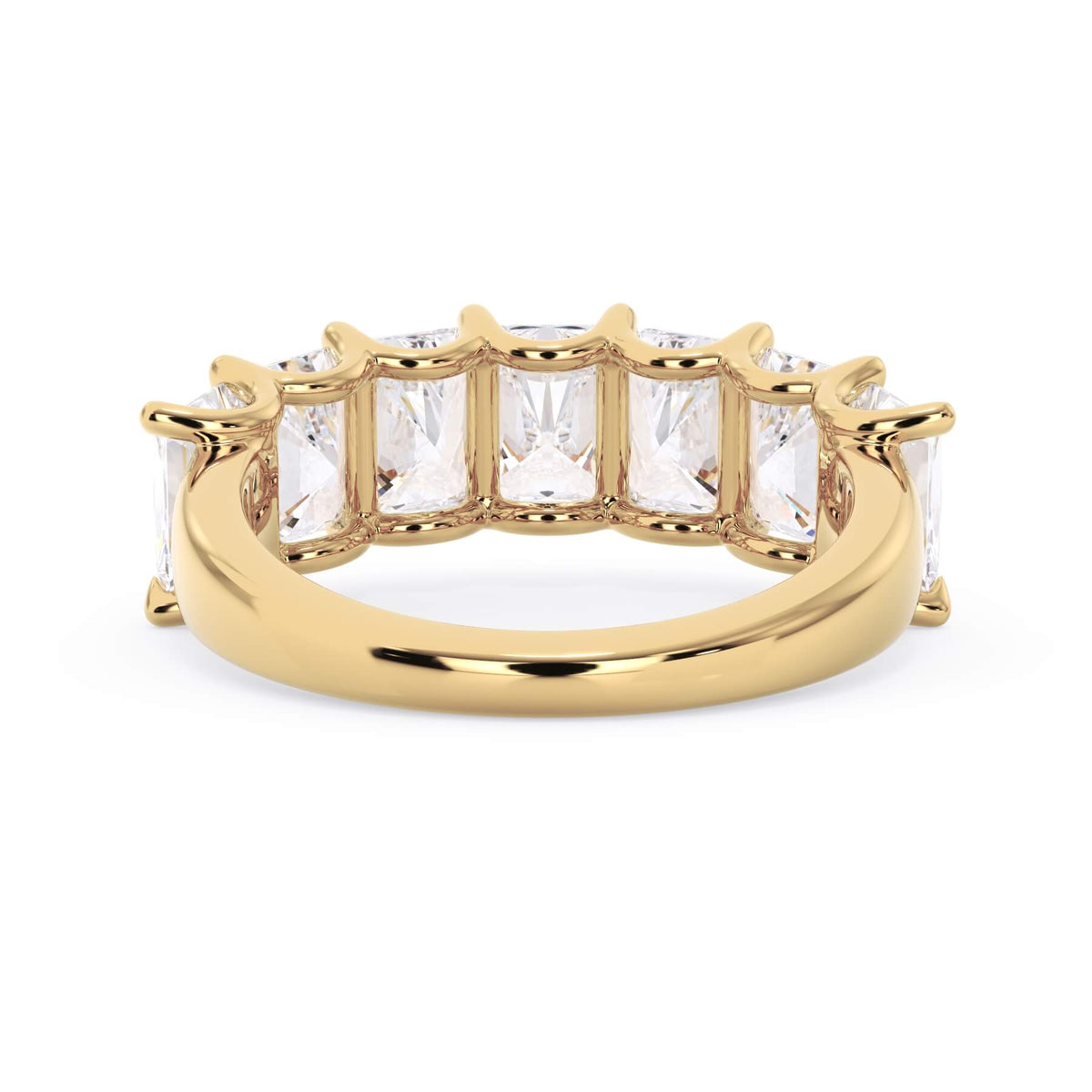 A picture of a seven stone diamond wedding ring with radiant cut diamonds that are U prong set in yellow gold on a white background with a view of the underside of the ring.